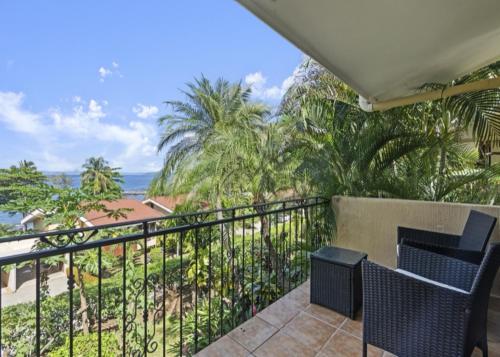 a balcony with chairs and a view of the ocean at Bahia Pez Vela Resort in Ocotal