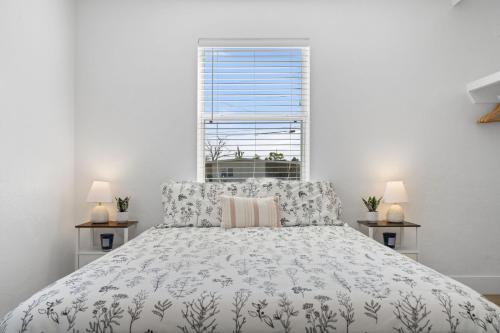 a white bedroom with a large bed and a window at Nestled in North Port in North Port