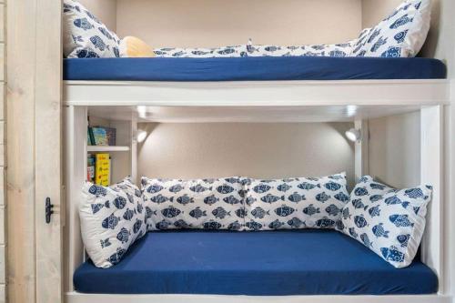 a bunk bed with blue and white pillows at Grand Caribbean 2009 in Port Aransas