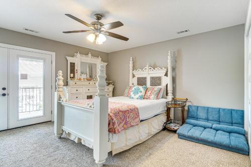 a bedroom with a white bed and a blue couch at Lakefront Boating Getaway in Spring City! in Spring City