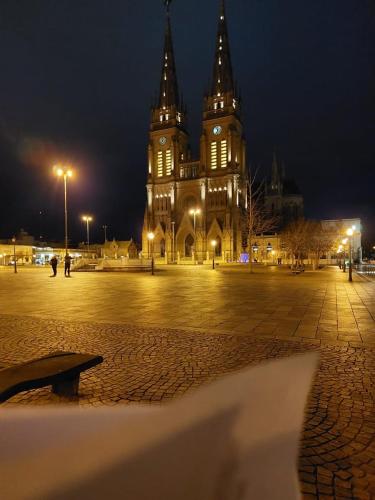 a large building with a clock tower at night at Duplex Victoria in Luján