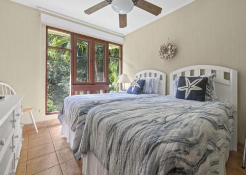a bedroom with a large bed with blue pillows at Bahia Pez Vela Resort in Ocotal
