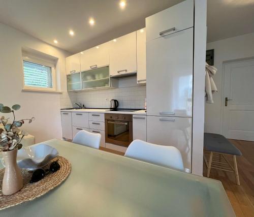 a kitchen with a white refrigerator and white cabinets at Bella Vita in Korčula
