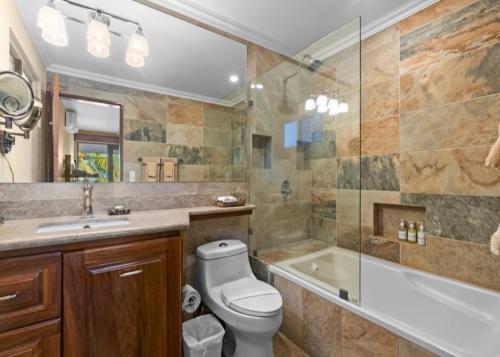 a bathroom with a toilet and a tub and a sink at Bahia Pez Vela Resort in Ocotal