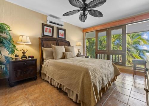a bedroom with a bed and a large window at Bahia Pez Vela Resort in Ocotal