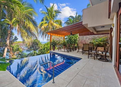 an exterior view of a house with a swimming pool at Bahia Pez Vela Resort in Ocotal