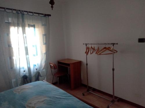 a bedroom with a bed and a desk and a window at La Corte del Gavi in Bosio