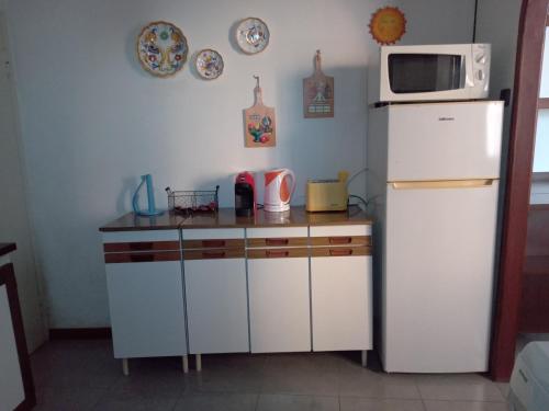 a kitchen with a white refrigerator and a microwave at La Corte del Gavi in Bosio