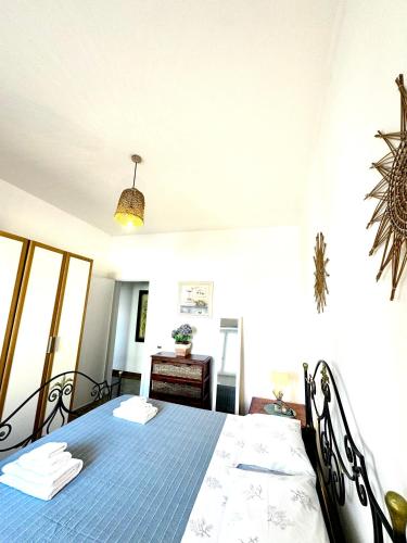 a bedroom with a blue bed and a table at Rivamare in Torre Squillace