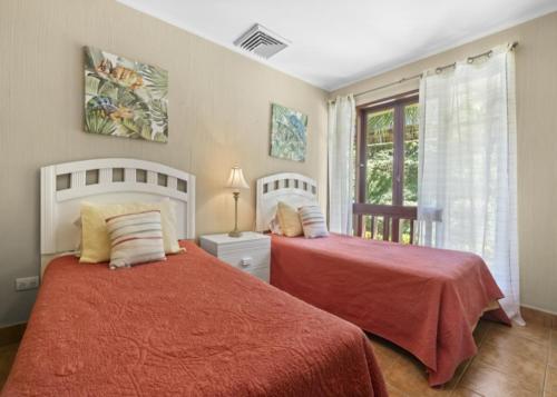 a bedroom with two beds and a window at Bahia Pez Vela Resort in Ocotal