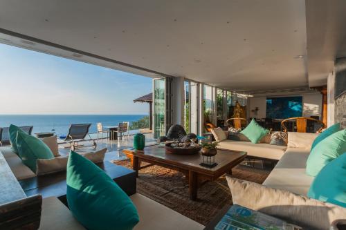 a living room with a view of the ocean at Bluesiam Villas - SHA Certified in Surin Beach