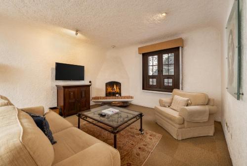 a living room with a couch and chairs and a fireplace at Hotel Museo Spa Casa Santo Domingo in Antigua Guatemala
