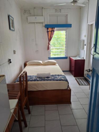 a bedroom with a bed in a room with a window at Tavua Hotel Ismail Investments in Tavua