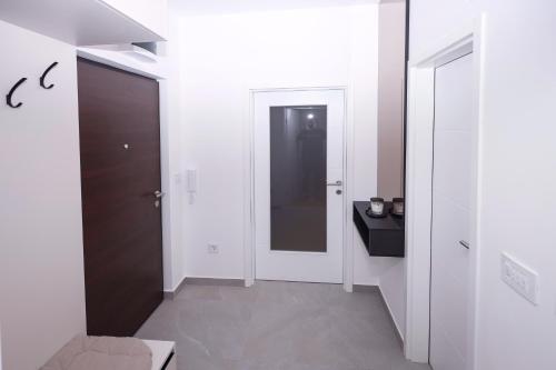 a room with a hallway with a door and a mirror at Central Rooftop Apartment in Trebinje