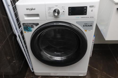 a white washing machine sitting in a kitchen at Central Rooftop Apartment in Trebinje