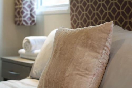 a pillow sitting on top of a bed with a window at Cosy cabin for 6 in Great Billing in Great Billing