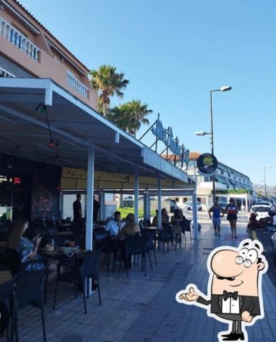 a cartoon character standing in front of a restaurant at Apartamento muy cerca de playas ocio y restauración en Candelaria Tenerife in Candelaria