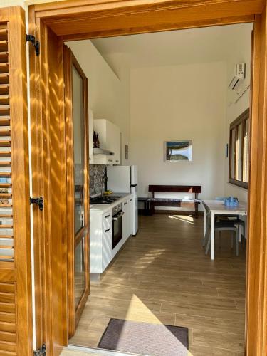 an open door to a kitchen with a table at Aria case vacanze in Favignana
