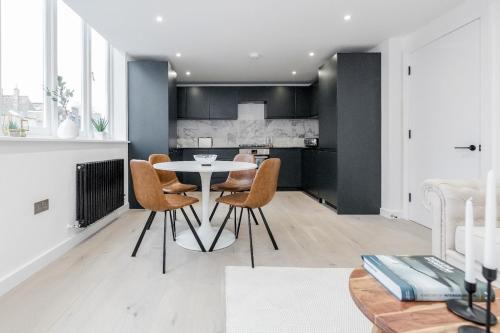 a kitchen and dining room with a table and chairs at 2Bed 2Bath Apartment in Liverpool Street, Steps to Brick Lane, Spitalfields & Shoreditch in London