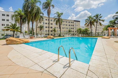 a swimming pool in front of a large building at Confortável apartamento, com wi-fi, pet friendly in Votorantim