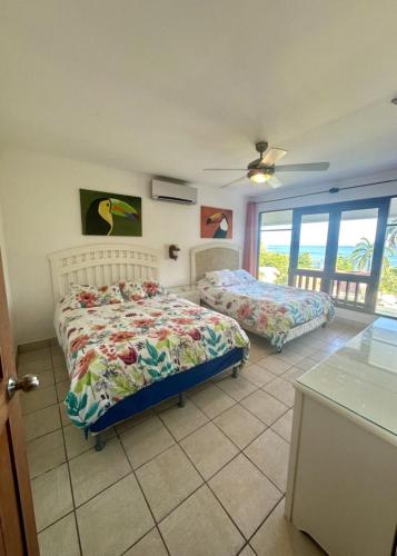a bedroom with two beds and a window at Bahia Pez Vela Resort in Ocotal