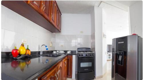 a kitchen with a sink and a refrigerator at Blue Pearl Cartagena in Cartagena de Indias