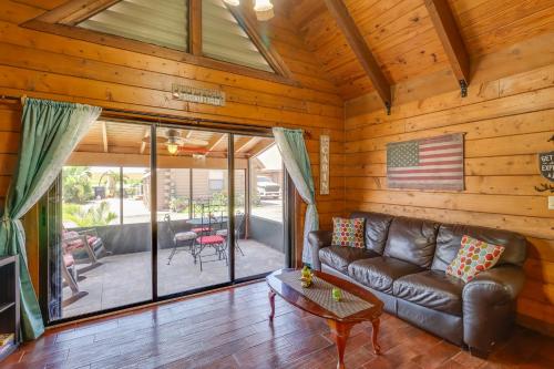 a living room with a leather couch in a cabin at Access to Lake Okeechobee Cabin with Perks! in Okeechobee
