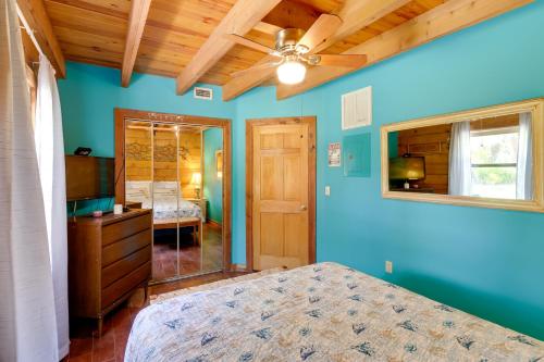 a bedroom with blue walls and a ceiling fan at Access to Lake Okeechobee Cabin with Perks! in Okeechobee