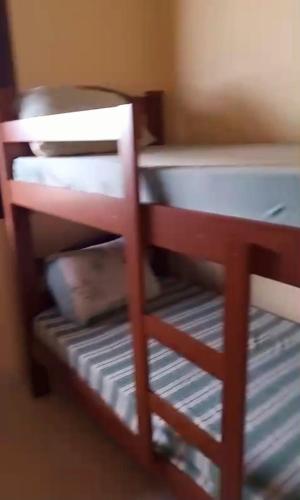a bunk bed in a room with a desk at Holidays in Itaipuaçu Beach in Maricá