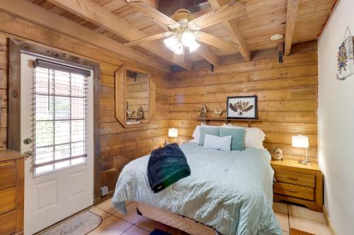 a bedroom with wooden walls and a bed and a ceiling at Cabin with Boat Launch and Pool Access in Okeechobee in Okeechobee