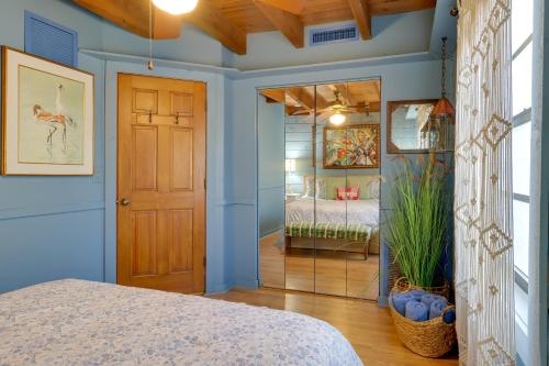 a bedroom with blue walls and a door and a bed at Fish On-Site Okeechobee Cabin with Pool Access in Okeechobee