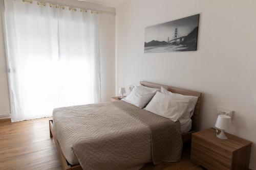 a bedroom with a bed and a large window at Dormen in Guspini