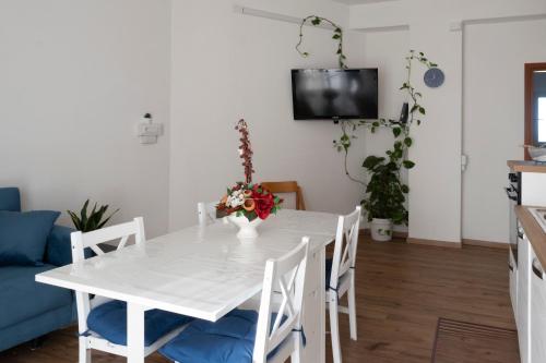 a white table and chairs in a living room at Dormen in Guspini