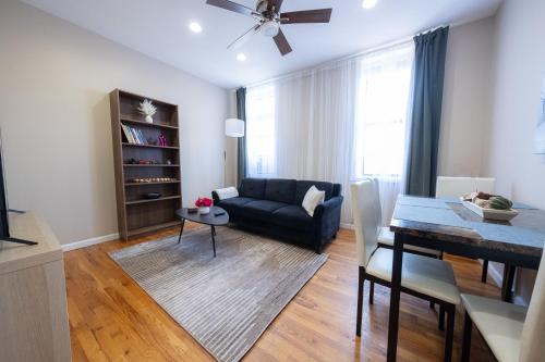 a living room with a couch and a table at 3 Bedroom Home In Manhattan in New York