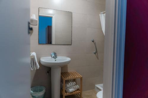 a bathroom with a sink and a mirror at Hostal Regina in Blanes