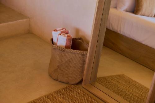 a bag of toiletries in front of a mirror at Casa Cambria in Puerto Escondido