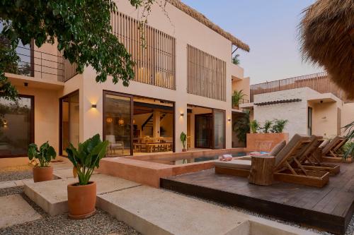 an exterior view of a house with a patio at Casa Cambria in Puerto Escondido