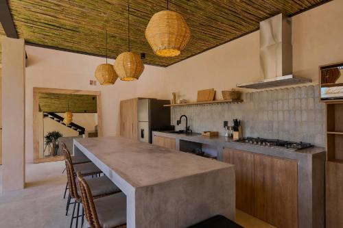 a kitchen with a large island in the middle at Casa Cambria in Puerto Escondido