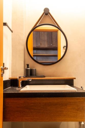 a bathroom with a sink and a mirror at Casa Bangalô dos Milagres in Passo de Camarajibe
