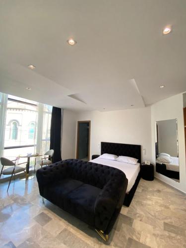 a large bedroom with a large bed and a couch at Hôtel Tlemcen médina in Tlemcen
