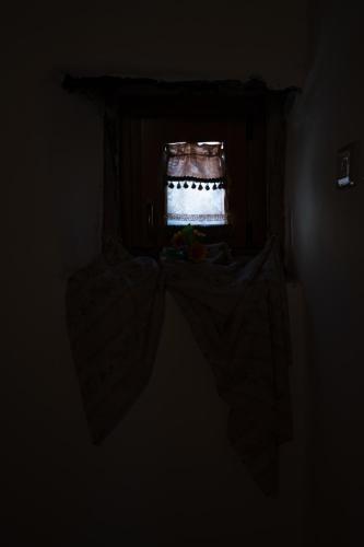 a dark room with a cake on a table at Rooms Parrinelli in Partinico
