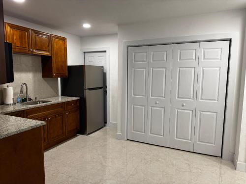 a kitchen with a white door and a refrigerator at New Aparment in Tampa in Tampa