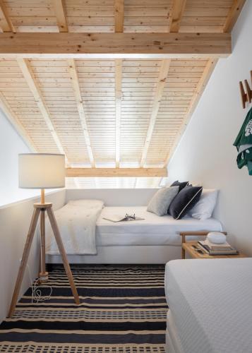 a bedroom with a bed with a wooden ceiling at FILETE, Design house in Peniche's old town in Peniche
