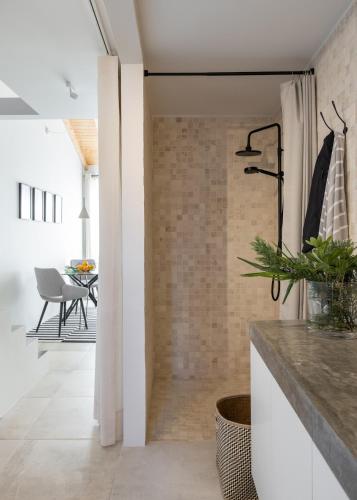 a kitchen with white walls and a brick wall at FILETE, Design house in Peniche's old town in Peniche