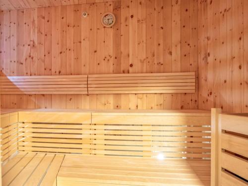 an empty sauna with a clock on the wall at Deluxe Zirberl Top 6 in Weisspriach