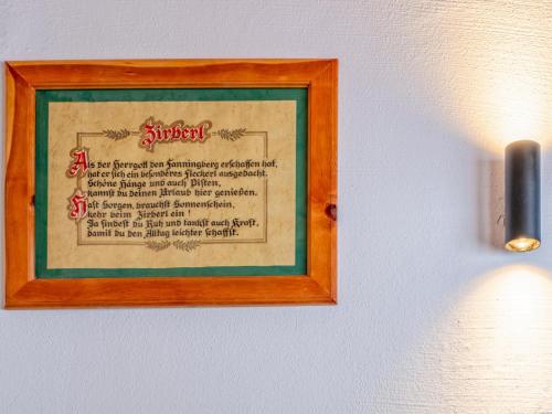 a picture in a wooden frame hanging on a wall at Deluxe Zirberl Top 6 in Weisspriach