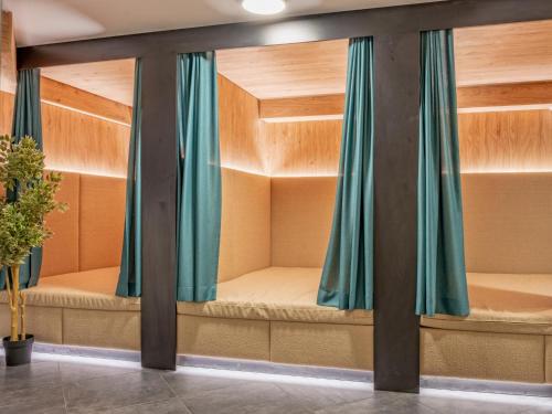 a room with three bunk beds with blue curtains at Deluxe Zirberl Top 6 in Weisspriach