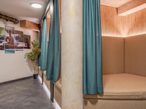 a corridor with blue curtains in a room at Deluxe Zirberl Top 6 in Weisspriach