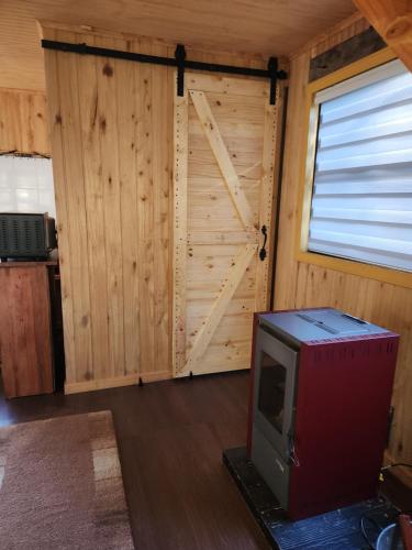 a room with a door and a tv in front of it at Cabaña de Iza, Sector Ensenada, Puerto Varas in Puerto Varas