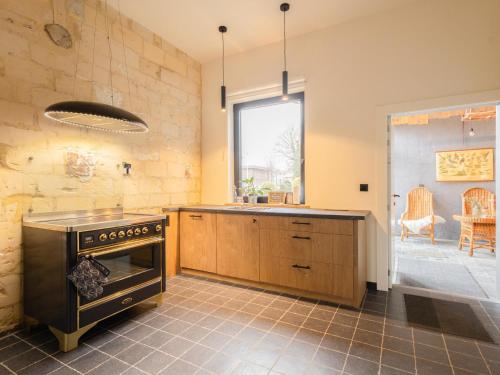 a kitchen with an oven in the middle of a room at Maison Cuberdon in Val-Meer